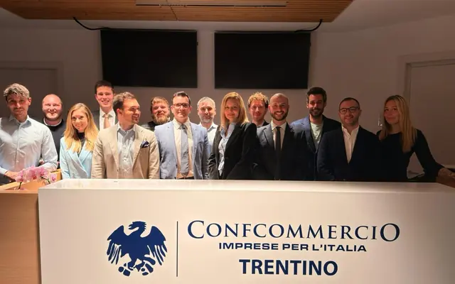 Il direttivo eletto nel 2026 in posa dietro il bancone con il marchio di Confcommercio Trentino